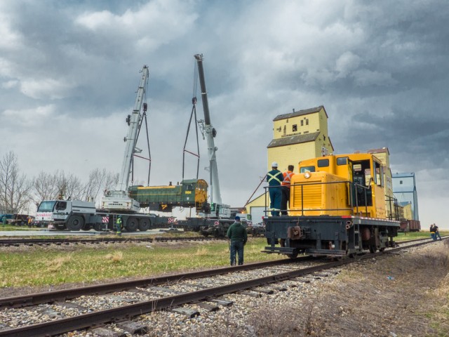 Cranes lifting locomotive